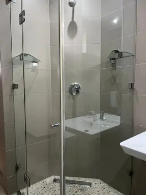 a shower with a sink and a glass shower door at 15 On Slice in Polokwane