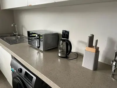 a kitchen counter with a coffee maker and a microwave at 15 On Slice in Polokwane