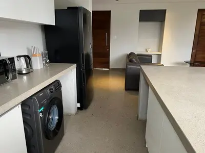 a kitchen with a washing machine in a kitchen at 15 On Slice in Polokwane