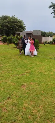 a group of people in dresses standing in a field at Marula Tree Lodge in Moletlane