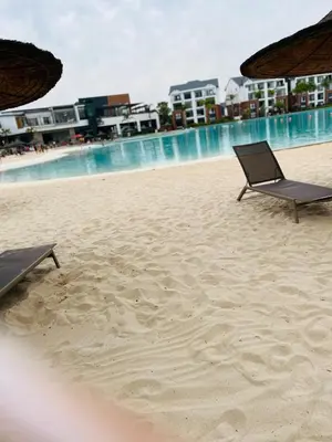 two chairs sitting on a beach near the water at The Blyde in Pretoria