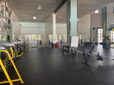 a gym with many chairs and machines in a room at The Blyde in Pretoria