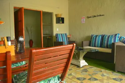 a living room with a couch and a table at Rural Villa Guesthouse in Naledi