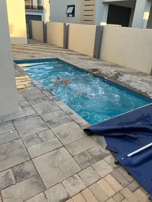 a small swimming pool with blue water in a building at Skylabs Housing in Polokwane
