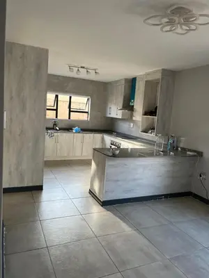 a large kitchen with a counter in the middle at Skylabs Housing in Polokwane