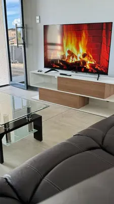 a living room with a fireplace and a couch at Skylabs Housing in Polokwane