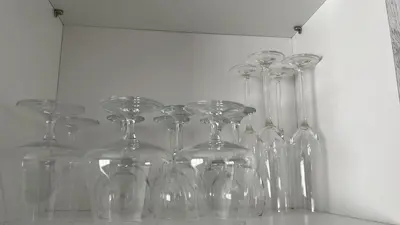 a group of glass wine glasses sitting on a shelf at Skylabs Housing in Polokwane
