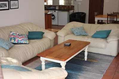 a living room with two couches and a coffee table at Doornboom Guesthouse in Pretoria