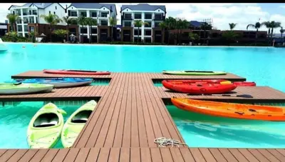 a group of kayaks on a dock in a pool at The blyde apartment in Pretoria