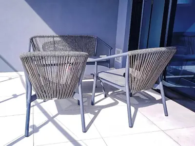 two wicker chairs and a table on a balcony at Ellipse Waterfall Executive Two Bedroom in Midrand