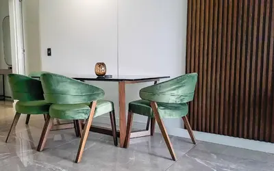 a table with two green chairs next to a table at Ellipse Waterfall Executive Two Bedroom in Midrand