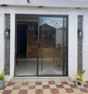 a sliding glass door of a house at Maoba GuestHouse in Soshanguve
