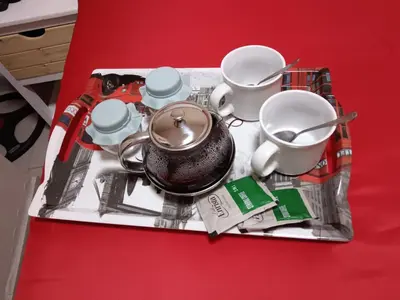 a tray with a tea pot and cups on a table at Maoba GuestHouse in Soshanguve