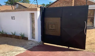 a black garage door in front of a house at Maoba GuestHouse in Soshanguve