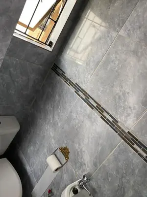 a bathroom with a toilet and a window at Maoba GuestHouse in Soshanguve
