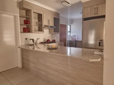 a kitchen with a large counter top in a room at Calm house by the river in Brits
