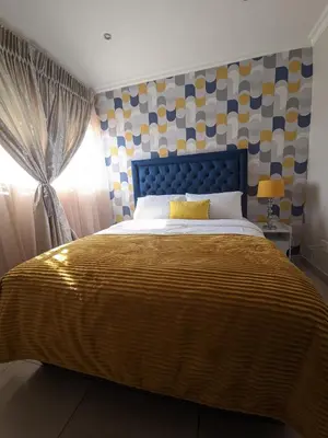 a bedroom with a large bed and a window at Calm house by the river in Brits