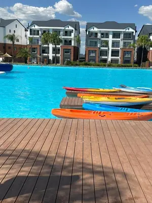 a group of kayaks sitting on a dock next to a swimming pool at The Blyde- Feel At Home in Pretoria