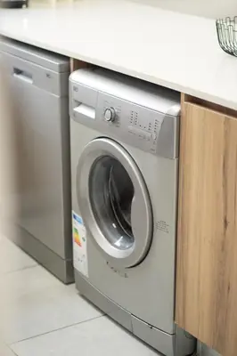 a washer and dryer under a counter in a kitchen at The Blyde- Feel At Home in Pretoria