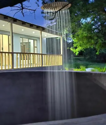 a house with a reflection in the water at Muca House in Thohoyandou