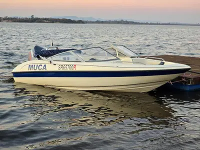 a white boat sitting on the water at Muca House in Thohoyandou