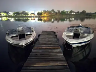 two boats are docked at a dock on a lake at Muca House in Thohoyandou