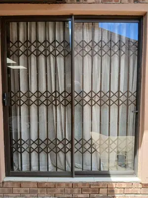a window with iron bars on a building at The Serenity in Polokwane