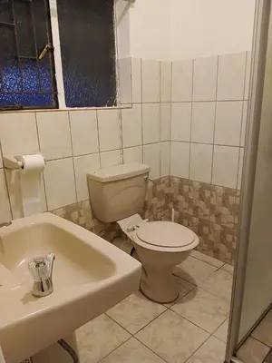 a bathroom with a toilet and a sink at The Serenity in Polokwane