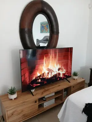 a tv sitting on a stand with a fireplace at The Serenity in Polokwane