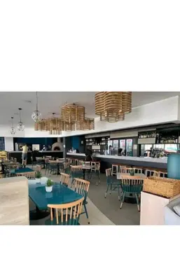 a restaurant with tables and chairs and a bar at Blyde Cozy-TEE'S Apartment in Pretoria