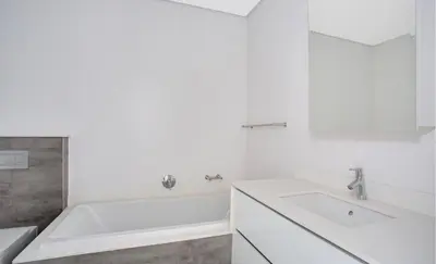 a white bathroom with a tub and a sink at Luxury palace of Life in Midrand