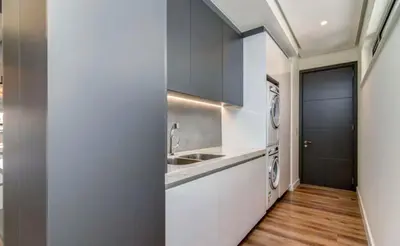 a kitchen with a sink and a washing machine at Luxury palace of Life in Midrand