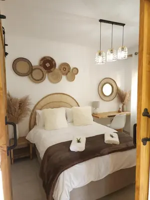 a bedroom with a bed with two towels on it at Bohemian Escape Midrand in Midrand