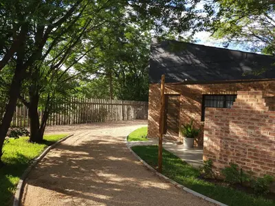 a brick house with a driveway at Bohemian Escape Midrand in Midrand