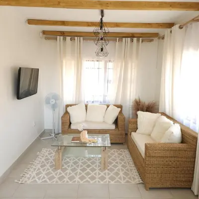 a living room with two couches and a table at Bohemian Escape Midrand in Midrand