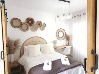 a bedroom with a bed with towels on it at Bohemian Escape Midrand in Midrand
