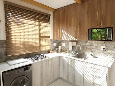 a kitchen with a sink and a washing machine at Bohemian Escape Midrand in Midrand