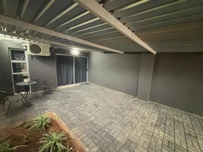 an empty room with a table and chairs in it at Nettle Nest Accommodation in Polokwane