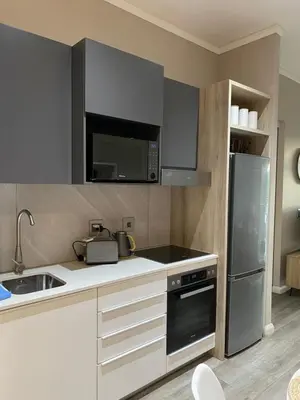 a kitchen with a sink and a refrigerator at Menlyn Maine Trilogy Apartment in Pretoria