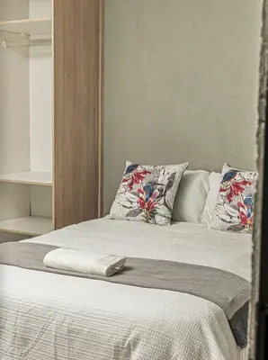 a white bed with pillows and a towel on it at Mahlakwena Crown Crest in Steelpoort