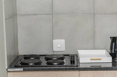 a kitchen counter with a stove top and a printer at Mahlakwena Crown Crest in Steelpoort