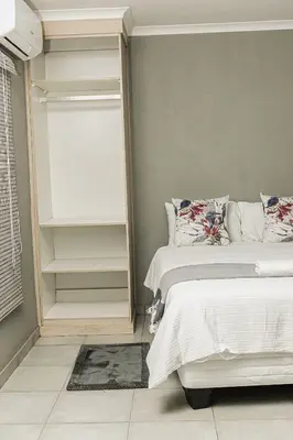 a bedroom with a bed and a window at Mahlakwena Crown Crest in Steelpoort