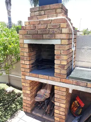 an outdoor brick pizza oven on a patio at Piano Inn in Centurion