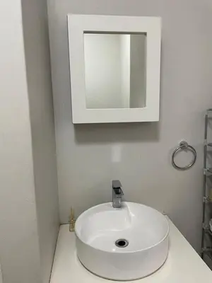 a bathroom with a white sink and a mirror at Stunning One Bedroom Apartment in Midrand in Midrand