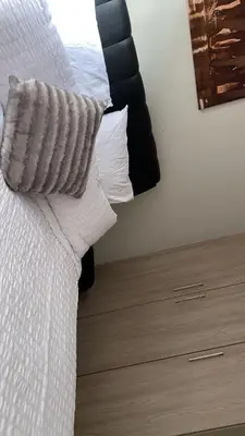 a bedroom with a bed with a pillow and a dresser at Stunning One Bedroom Apartment in Midrand in Midrand