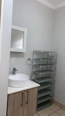 a bathroom with a sink and a mirror at Stunning One Bedroom Apartment in Midrand in Midrand