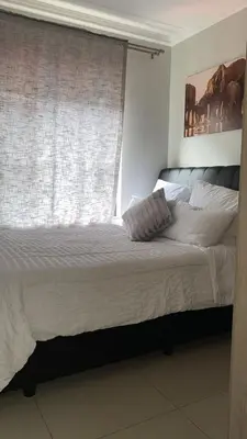 a bedroom with a large bed with a window at Stunning One Bedroom Apartment in Midrand in Midrand