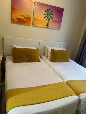 two beds sitting next to each other in a room at 2e - No load shedding 2 bed home to relax into in Centurion