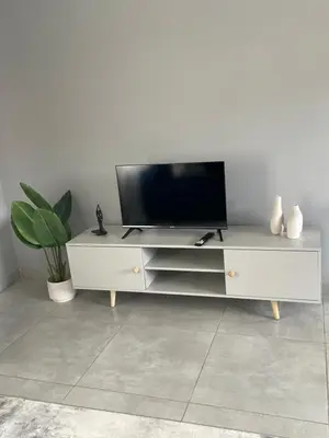 a white entertainment center with a flat screen tv on it at Serenity at Homely Escapes in Phalaborwa