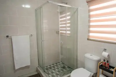 a bathroom with a glass shower with a toilet at Serenity at Homely Escapes in Phalaborwa